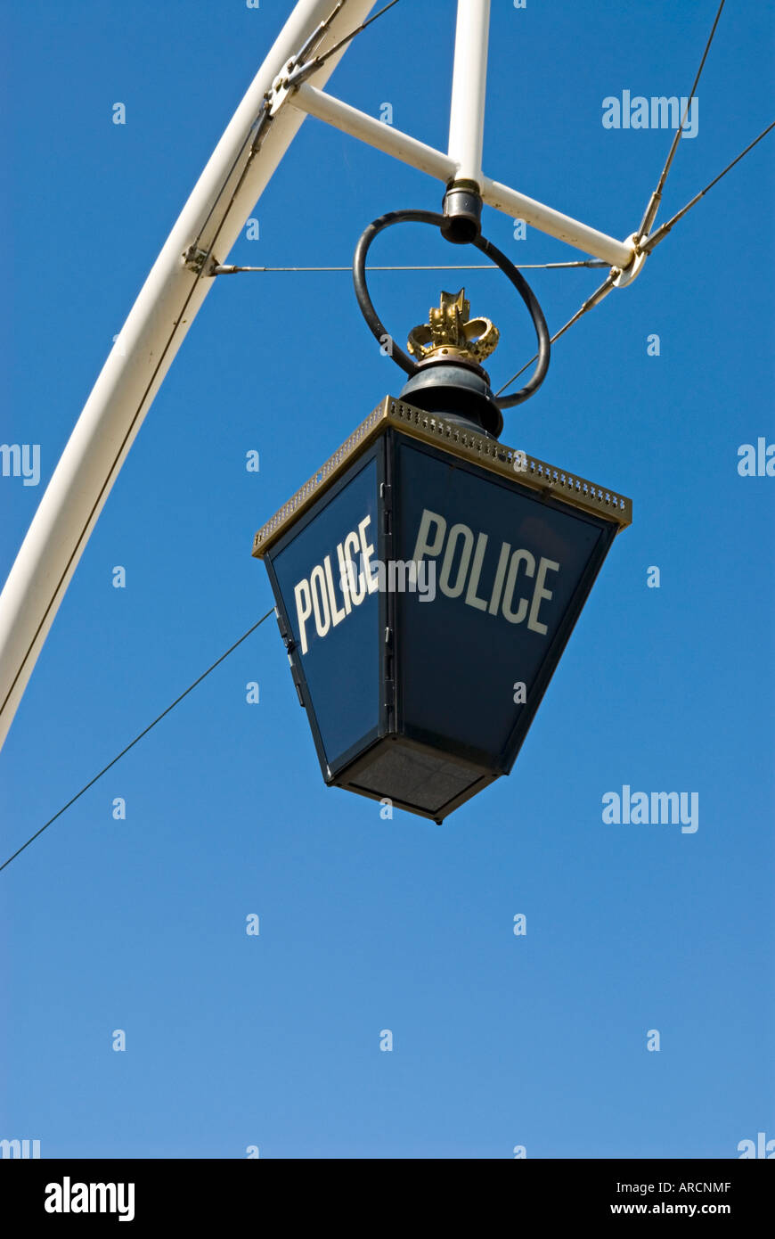 A traditional blue lamp suspended outside a police station Stock Photo