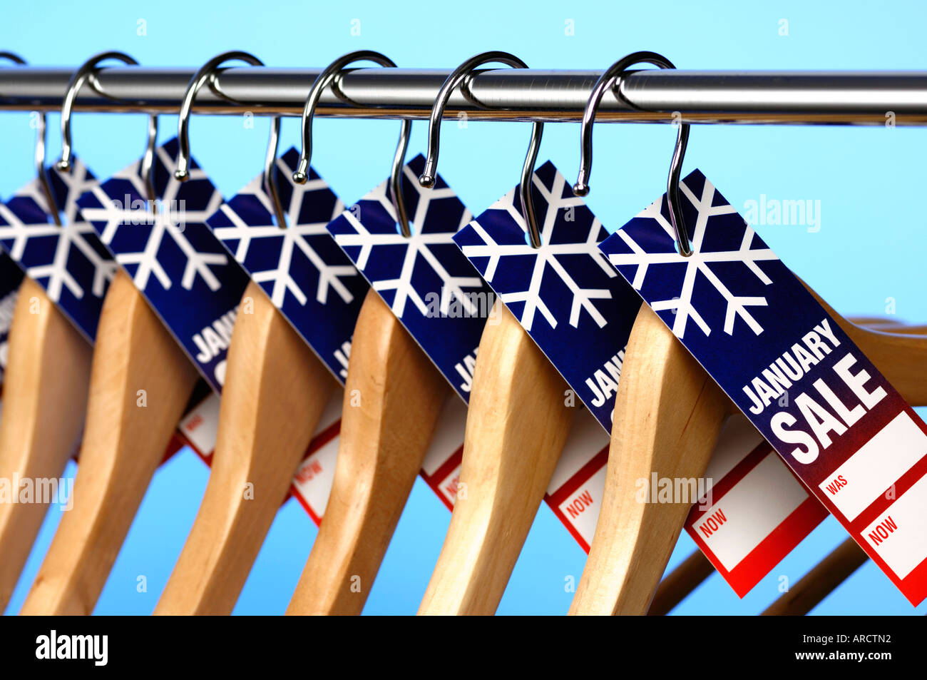 Row of wooden coathangers with January Sale price tags Stock Photo