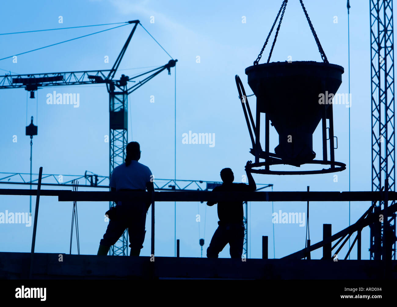 Building labourers at work on a construction site Stock Photo