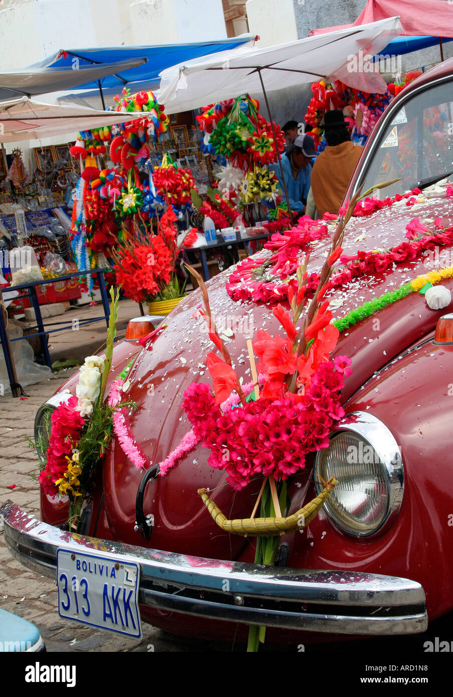 Beetle car adorned with flowers and garlands for the traditional car blessing service in Copacabana, Bolivia, South America. Stock Photo