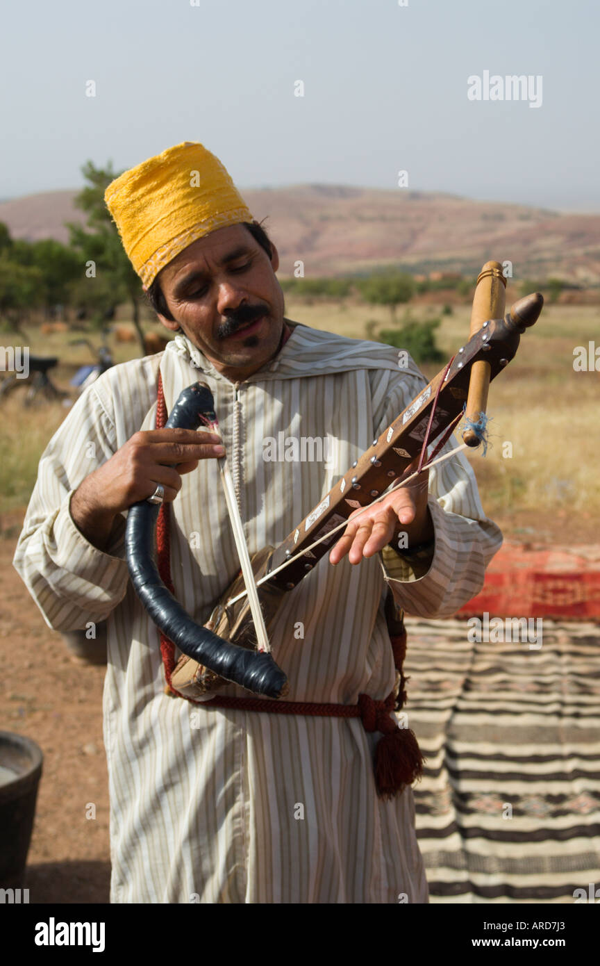 Traditional Moroccan folk fiddle player and singer performs at an agrotourisme show farm near Marrakesh Morocco Stock Photo