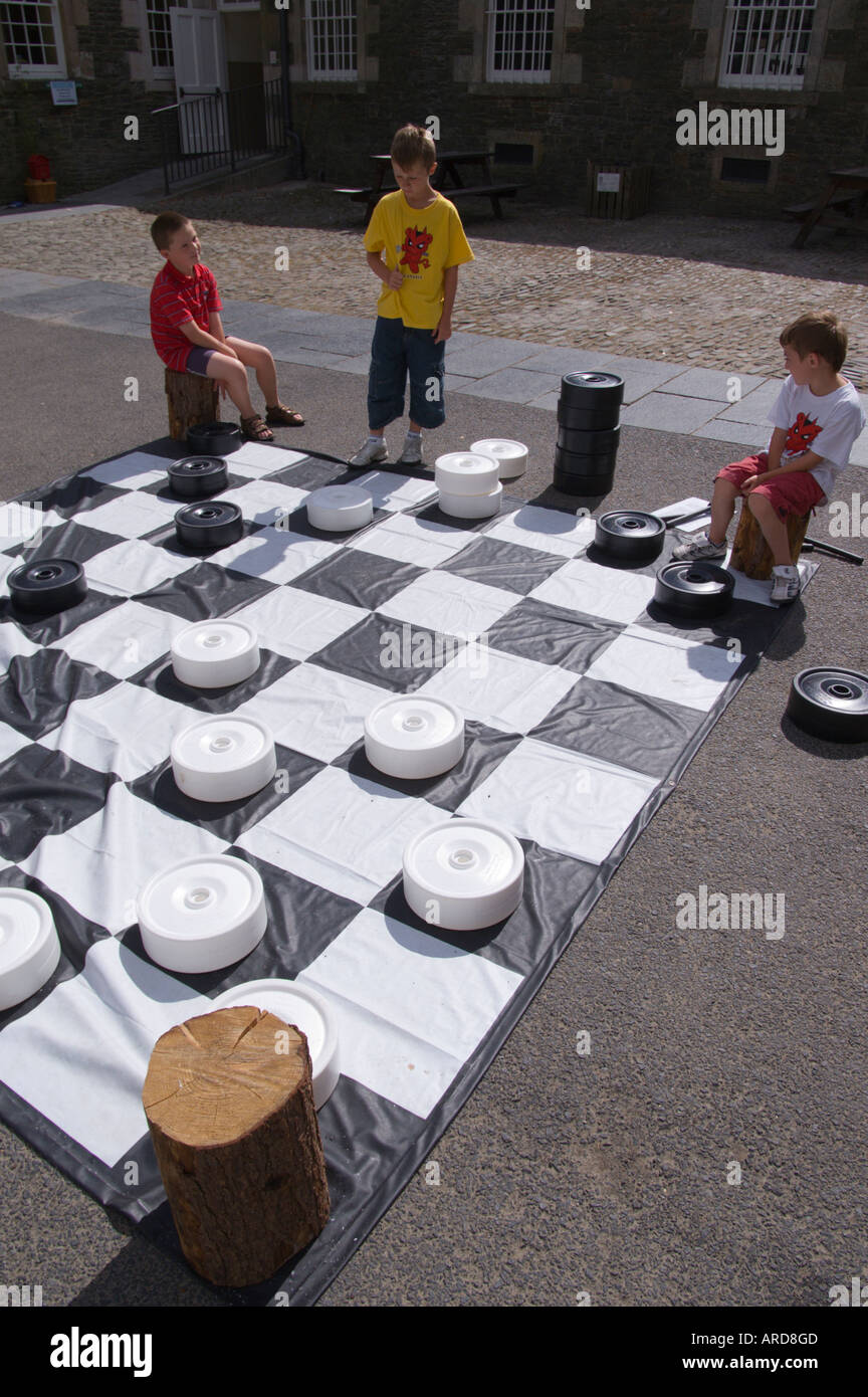 At Bowhill House in the Scottish Borders UK children play giant checkers in the court Stock Photo