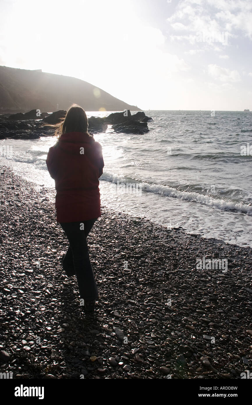 Girl walking along beach Stock Photo