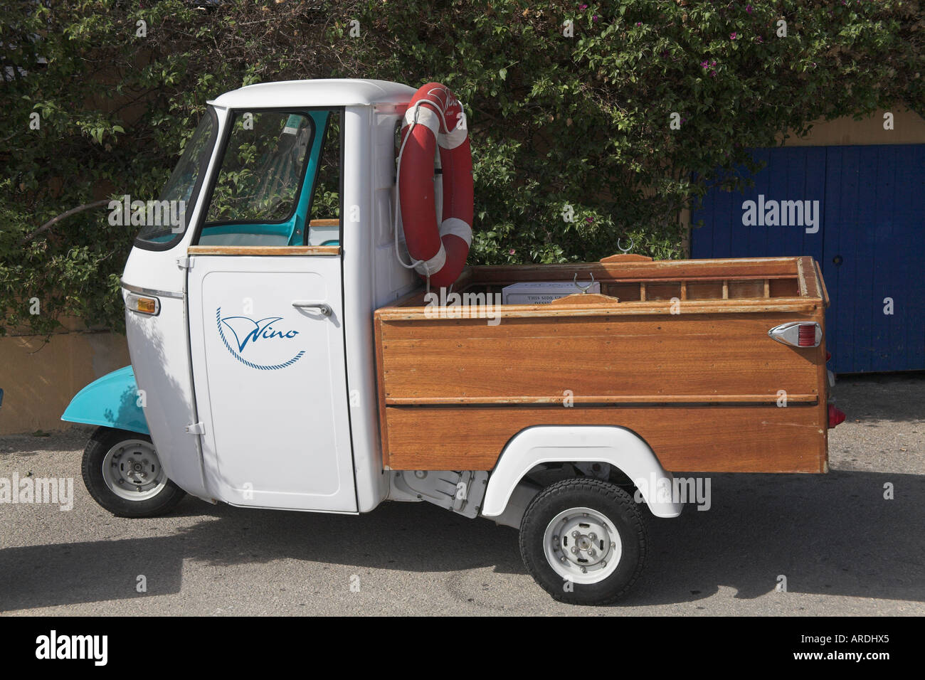 Stock photograph of Piaggio ape vespa made scooter based mini pickup at Cassis kitted out as rowing boat Stock Photo