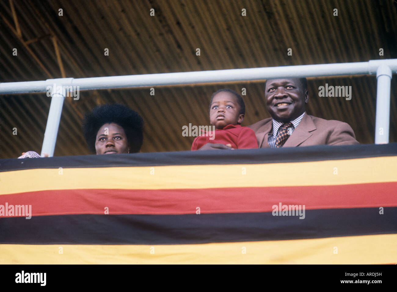 Uganda president Idi Amin smilingly watches Uganda national day events with  fourth wife Madfina and Mwangi, one of many children Stock Photo - Alamy