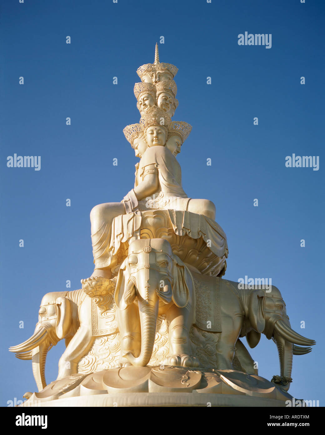 Multi faceted Buddha statue at top of Emei Shan Stock Photo