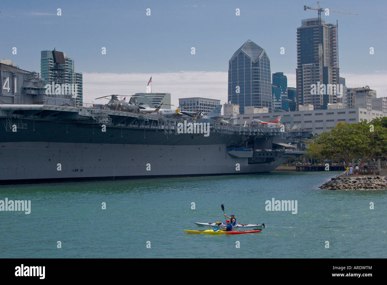 Kayak approaching the USS Midway, San Diego California Stock Photo