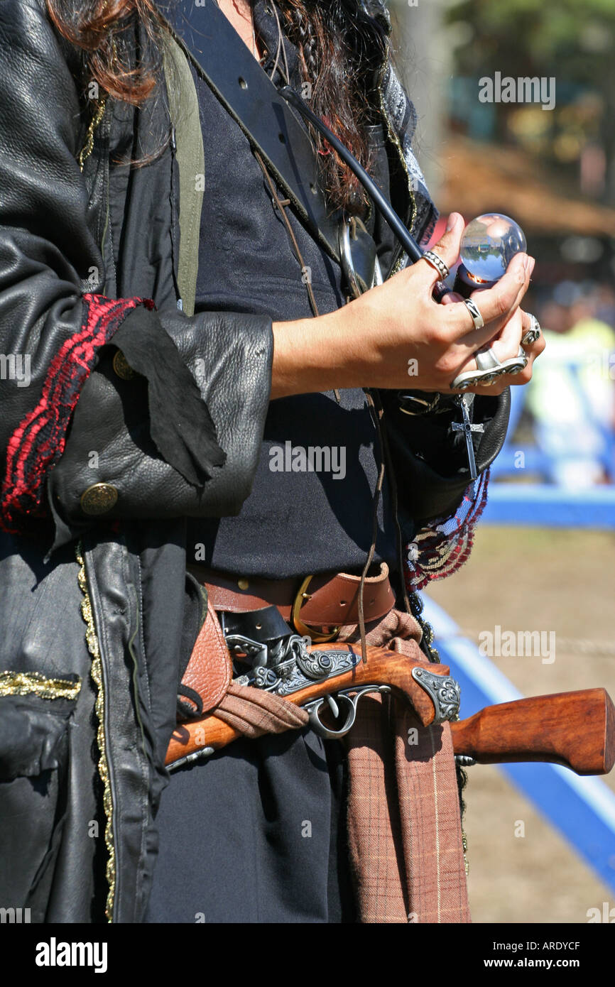 Pirate dressed man lighting his pipe with a magnifying glass on King Richard s Faire 2005 Carver Massachusetts Stock Photo