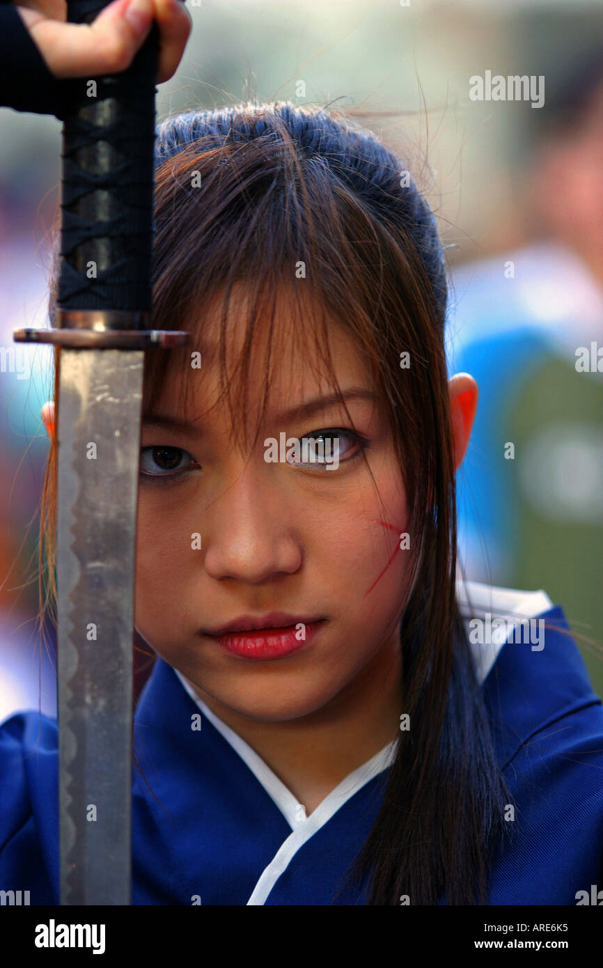 Thailand Bangkok portrait of young Thai woman in traditional dress with a sword Stock Photo