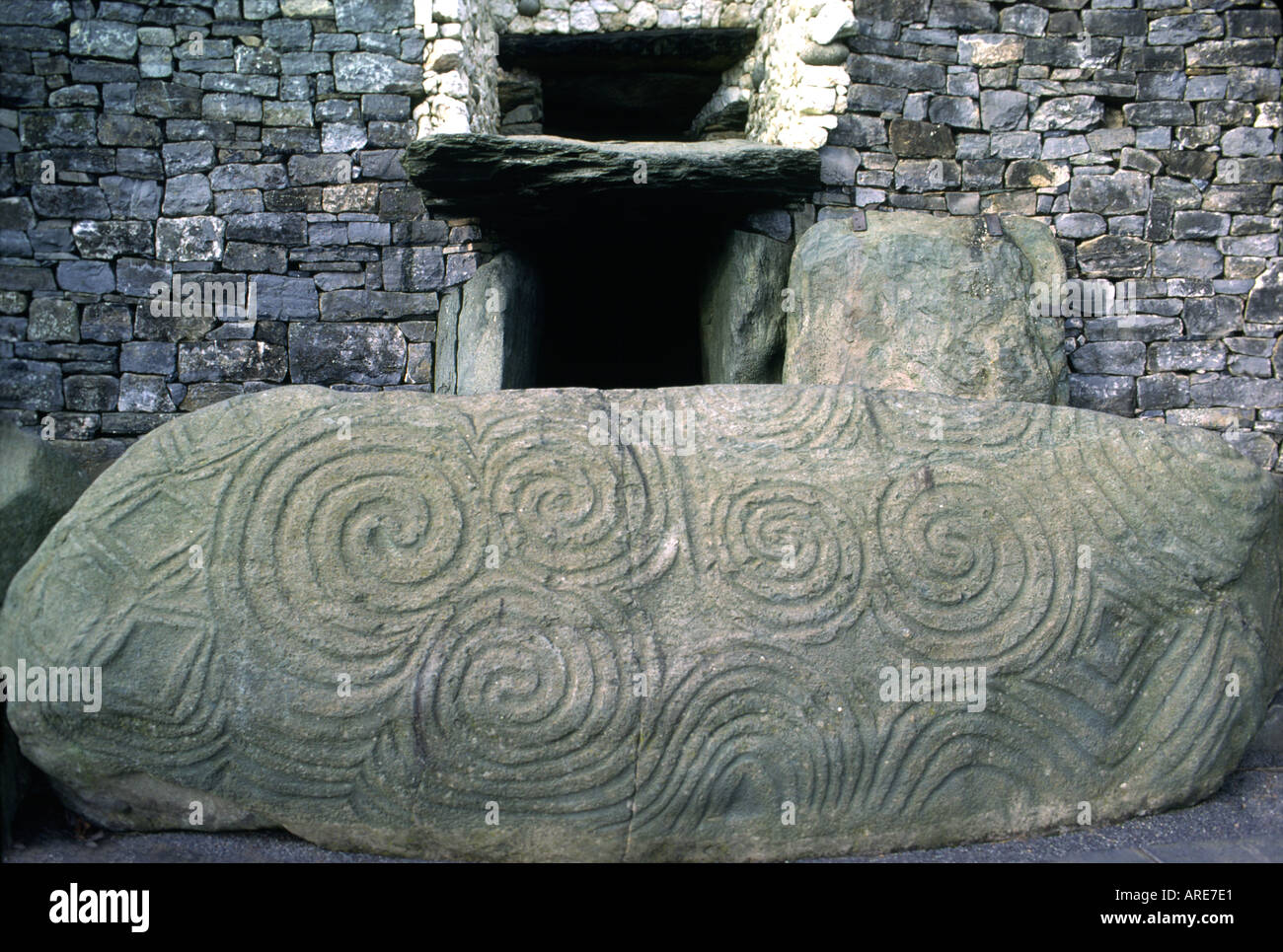 Newgrange prehistoric passage mound. County Meath, Ireland. Decorated carved spiral and triskele stone at the passage entrance. Stock Photo