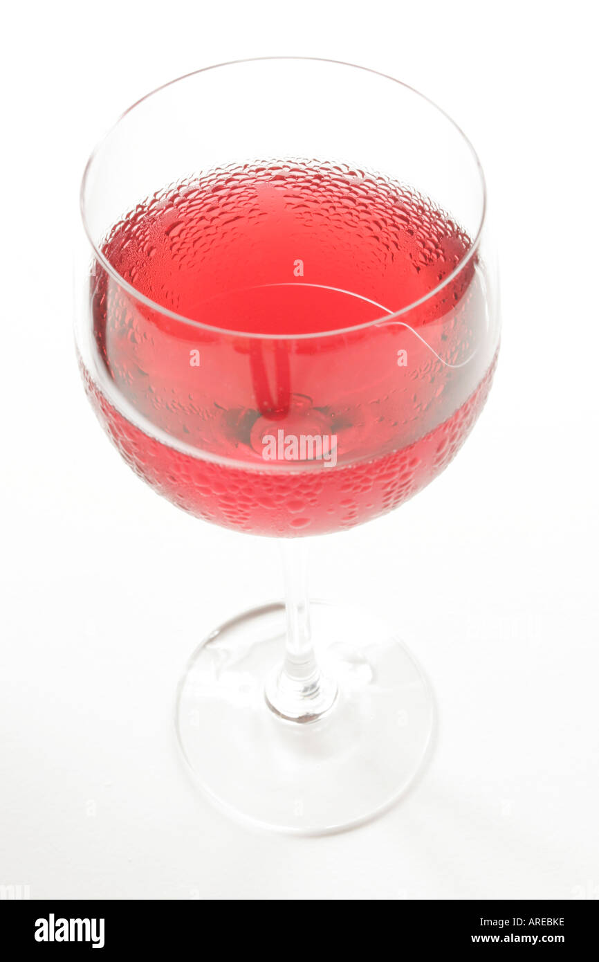High key shot of a glass of chilled rose wine isolated against a white