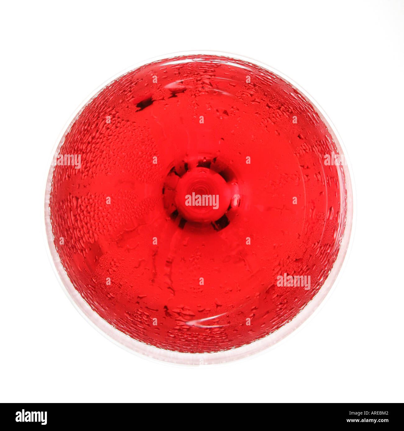 Overhead view of a glass of chilled rose wine isolated against a white