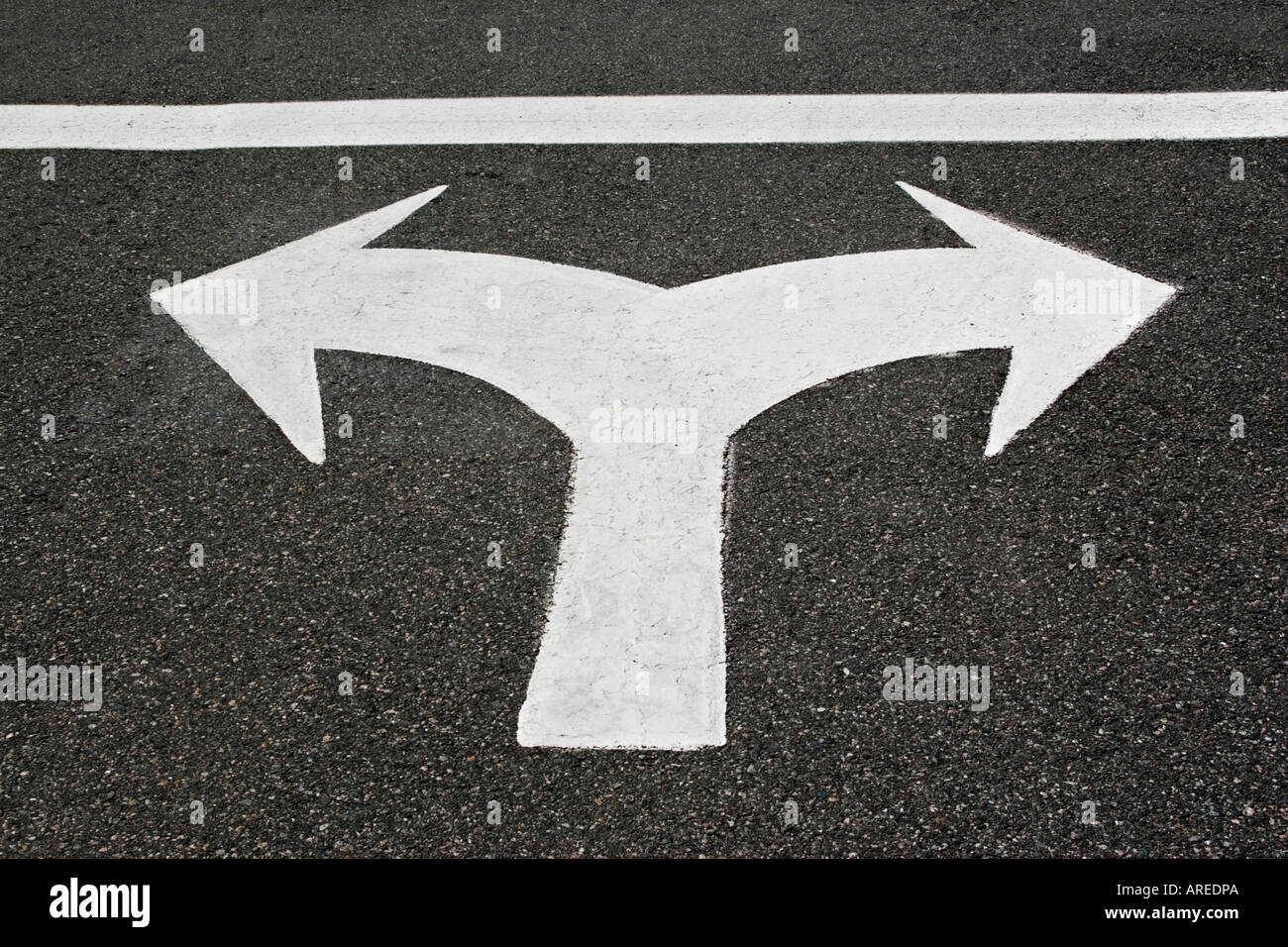 Dual directional arrows indicating must turn left or right painted on