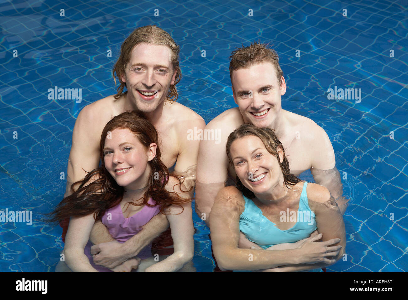 Portrait of four friends in a pool Stock Photo