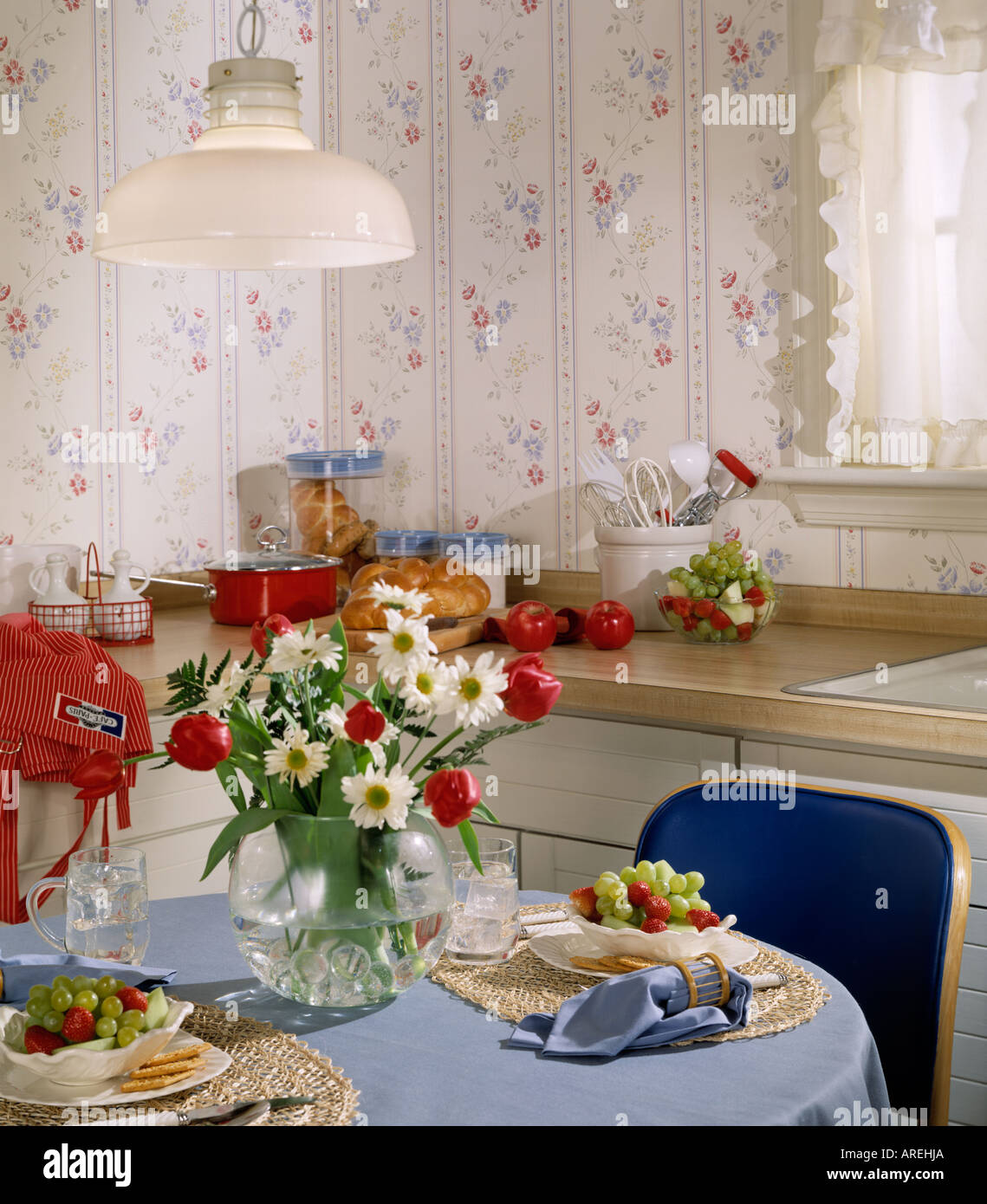 interior room kitchen counter table floral arrangement food Stock Photo