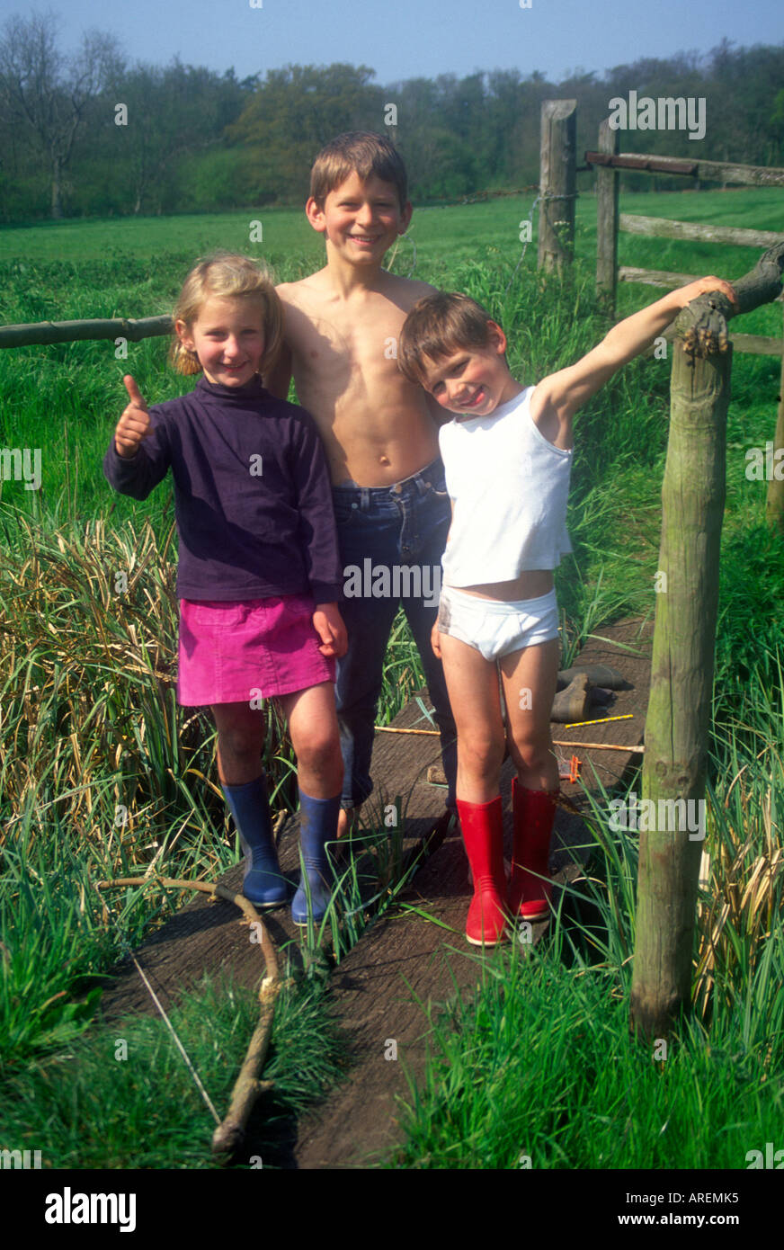Non Identical Boy Girl Twins Playing In A Field With Their Big Brother Stock Photo Alamy