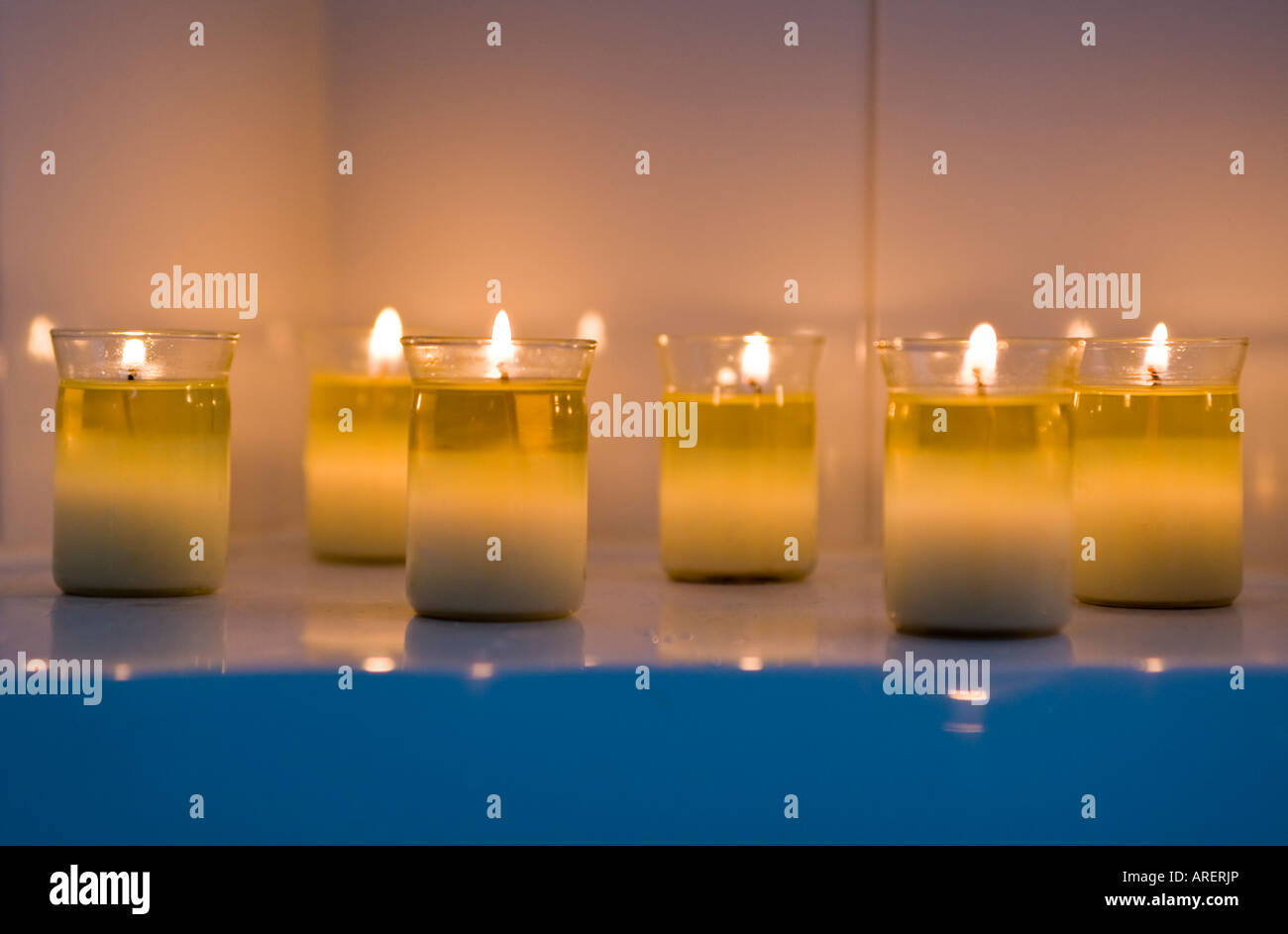 Small candles burning in a spa to create a calming environment Stock Photo