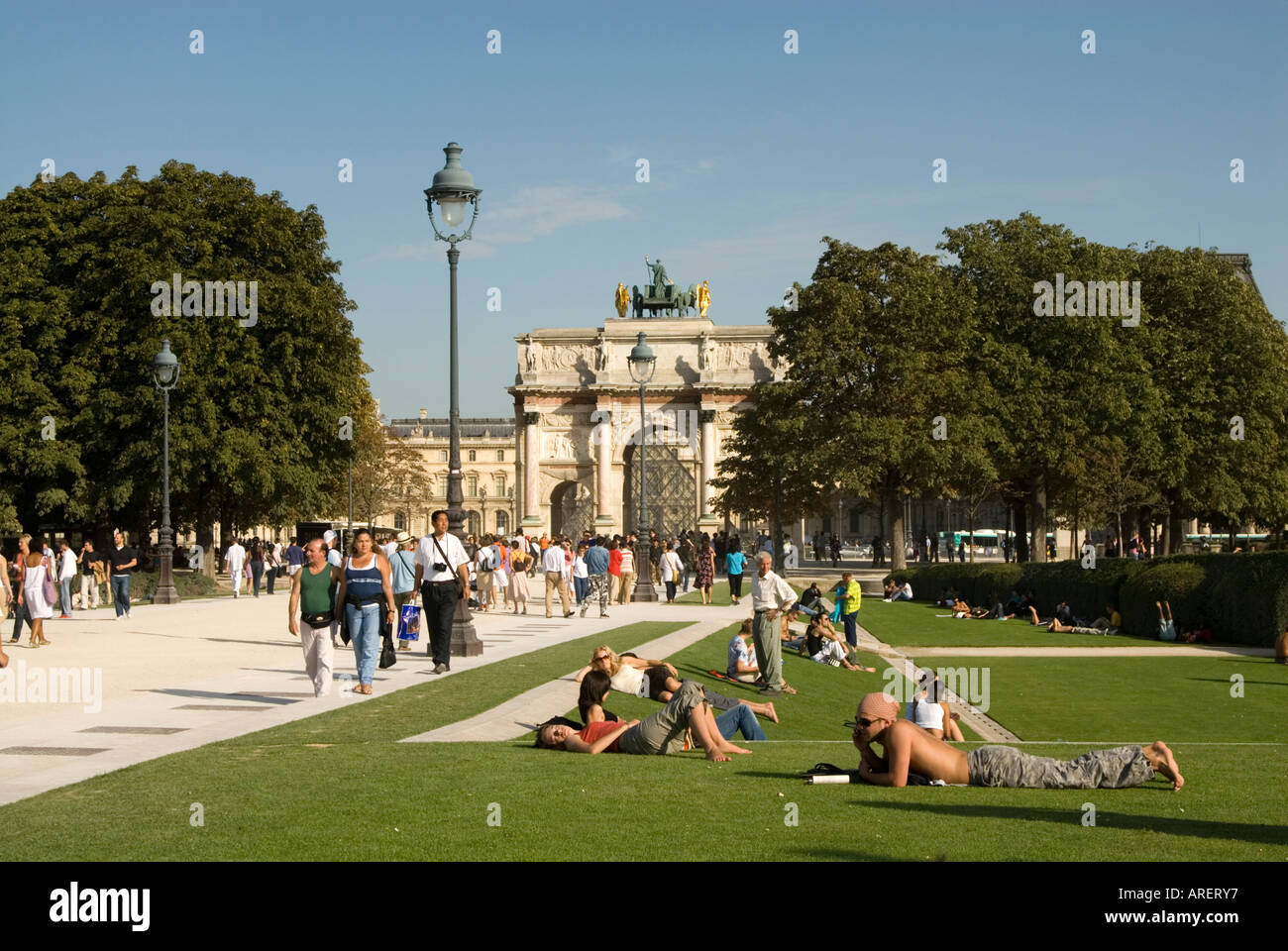 People relaxing on the grass in the Jardin du Carrousel, Paris France Stock Photo