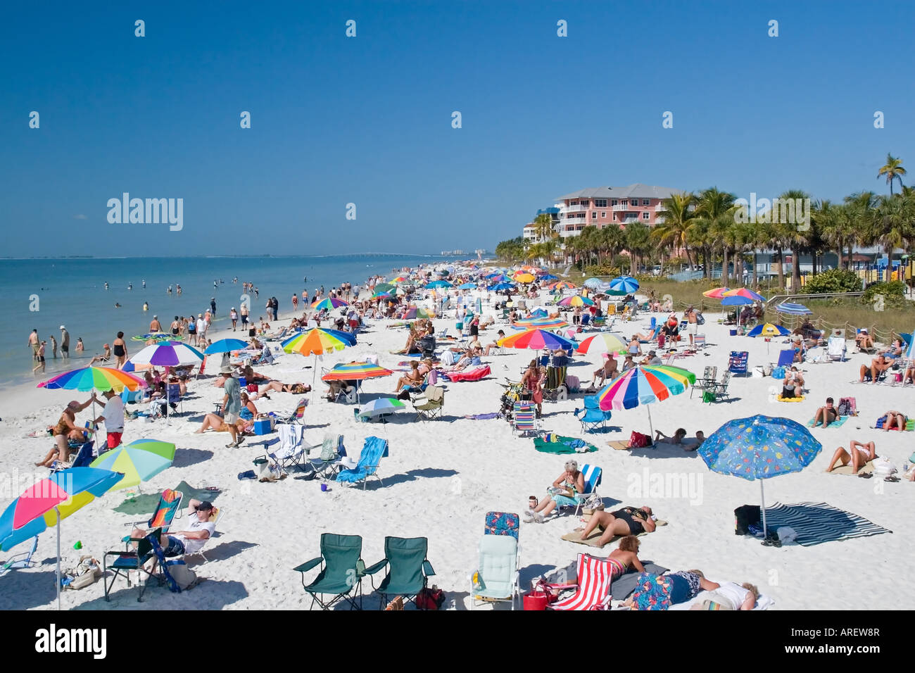 Tourists on the beach for summer vacation and in the water Stock Photo