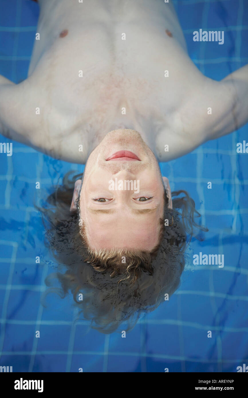 Portrait of a man floating in a pool Stock Photo