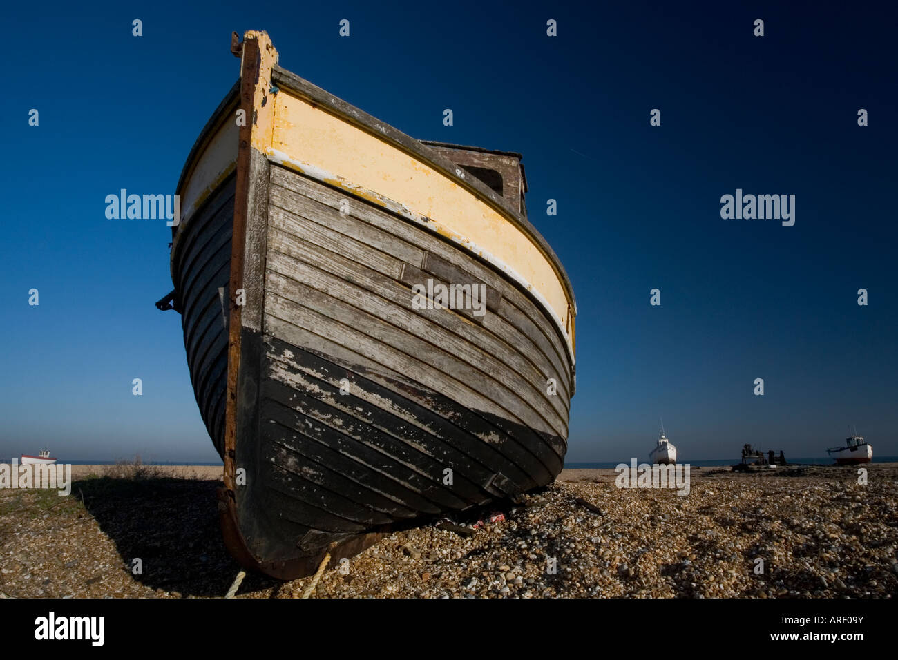 Old wooden fishing boat on shingle beach Stock Photo - Alamy