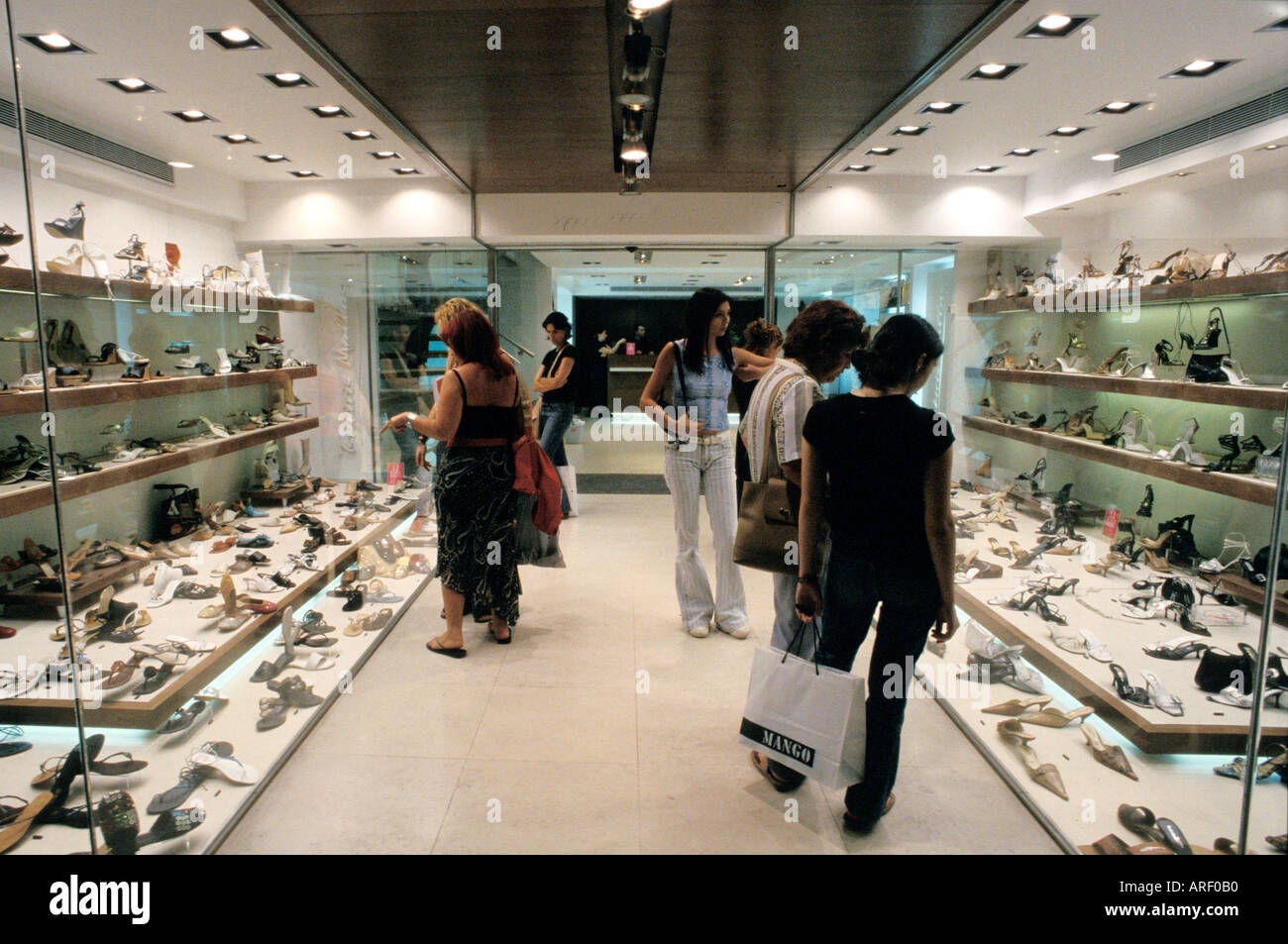 Shoe shopping in pedestrianised Ermou street central Athens Greece