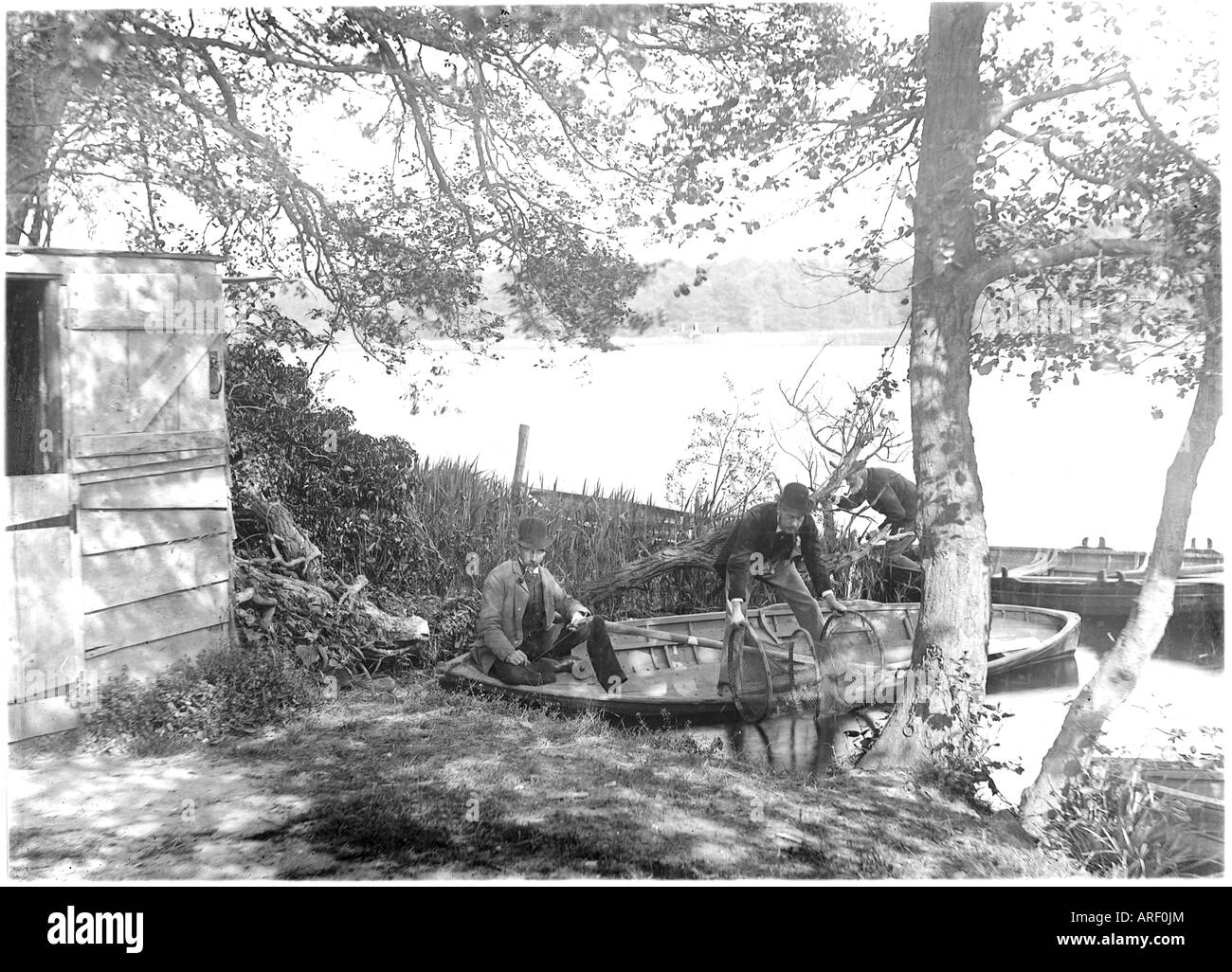 men in fishing boat on norfolk broads, c 1910 Stock Photo