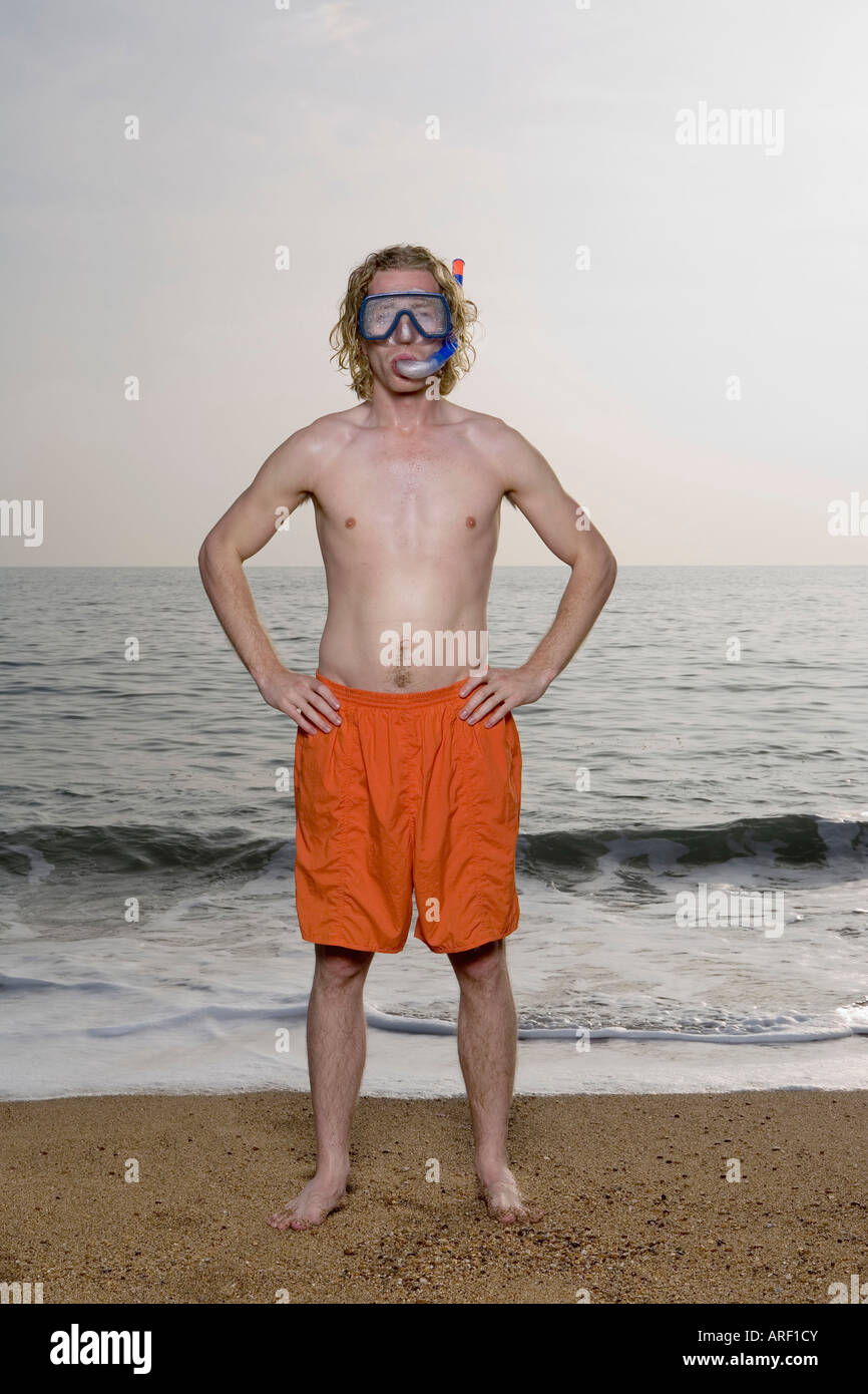 Man wearing mask on beach Stock Photo