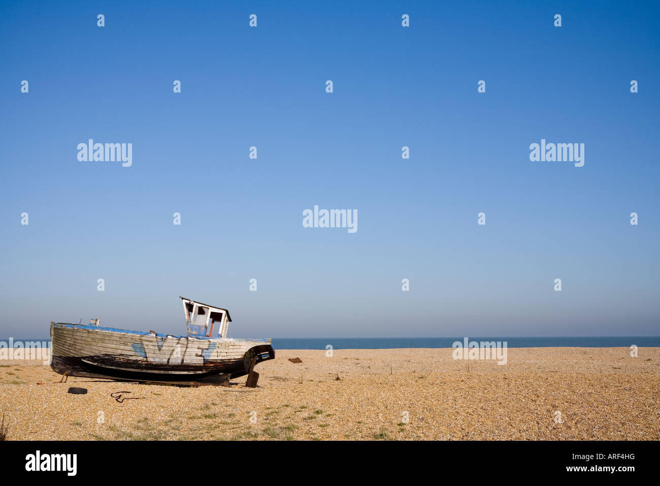 Old weathered fishing boat on a pebble beach in Dungeness, Kent on a ...
