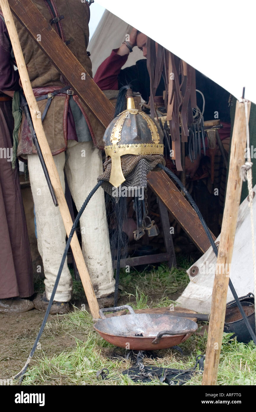 Viking helmet drying over a fire at a re-enactment festival in Denmark Stock Photo
