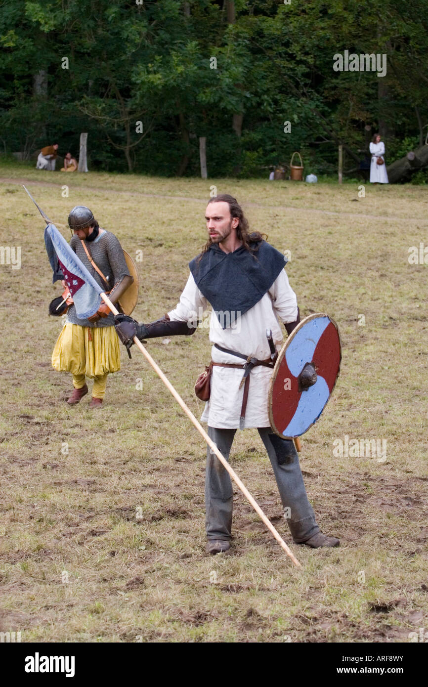 Viking flag bearer in the middle of the battlefield at a re-enactment in Denmark Stock Photo
