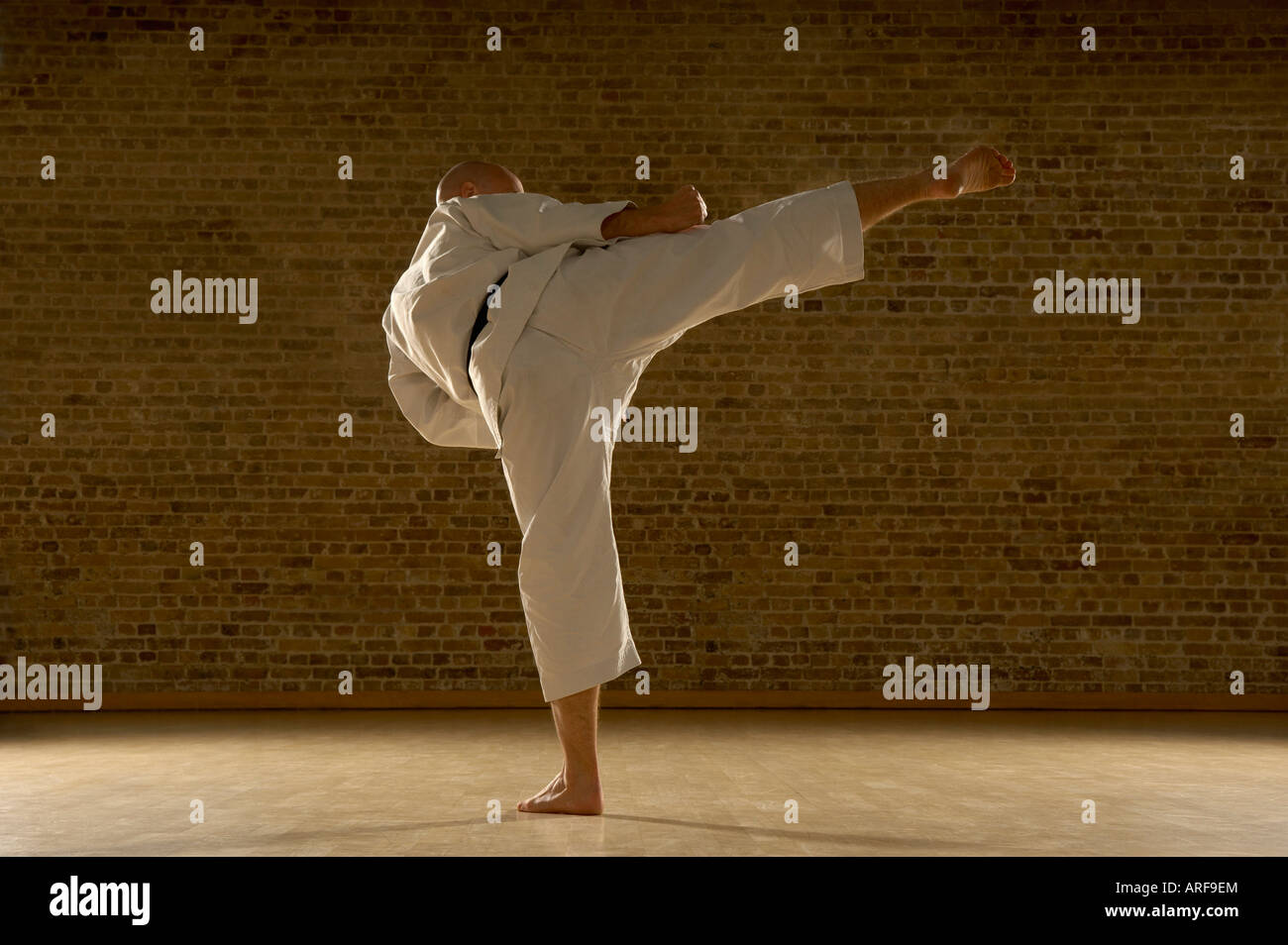 Karate man kicking Stock Photo