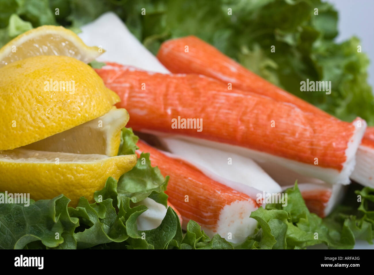 Closeup of Surimi crab sticks on lettuce salat and lemon seafood sea