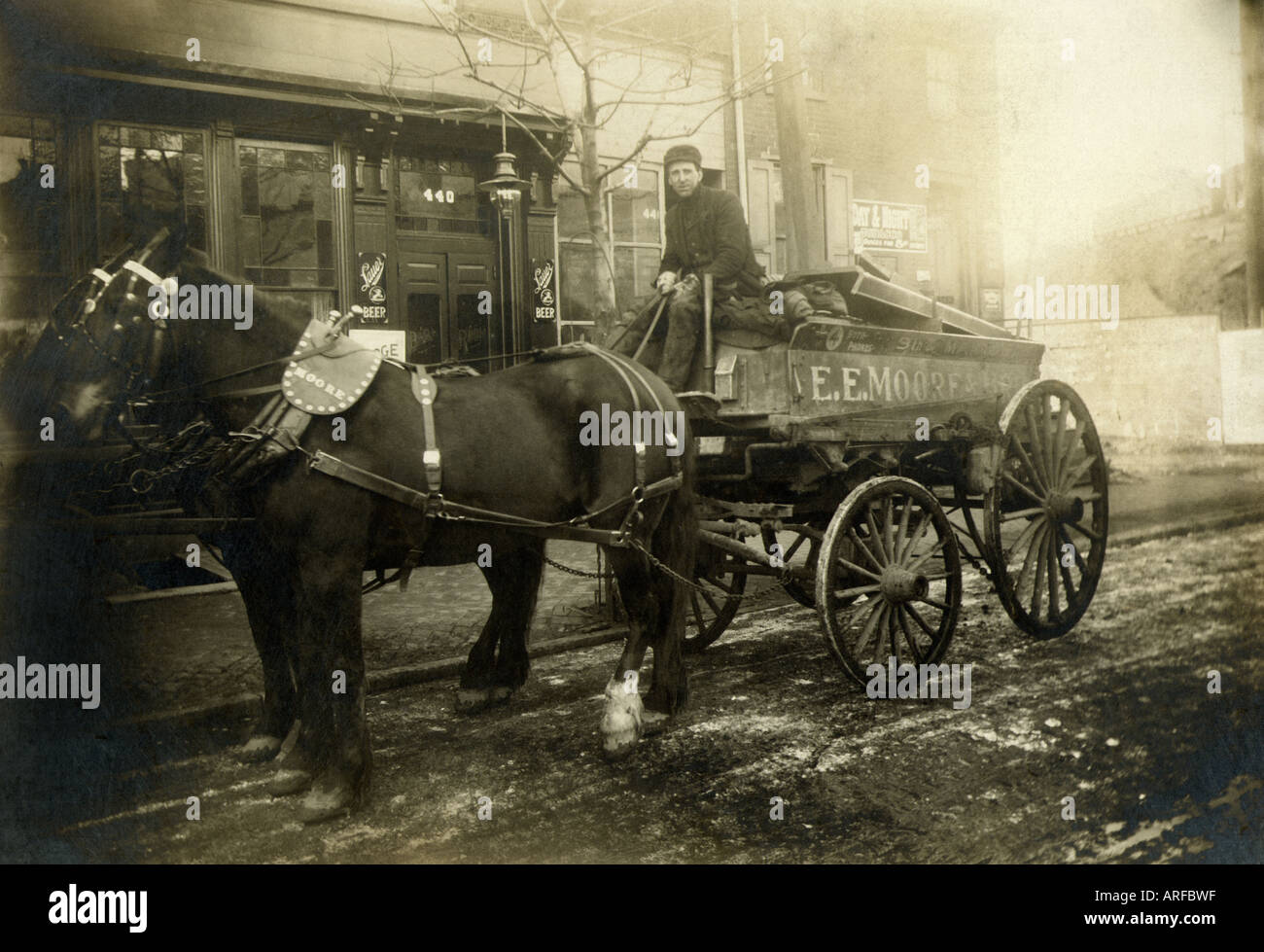 Circa early 1900's horse drawn coal wagon delivery man Stock Photo