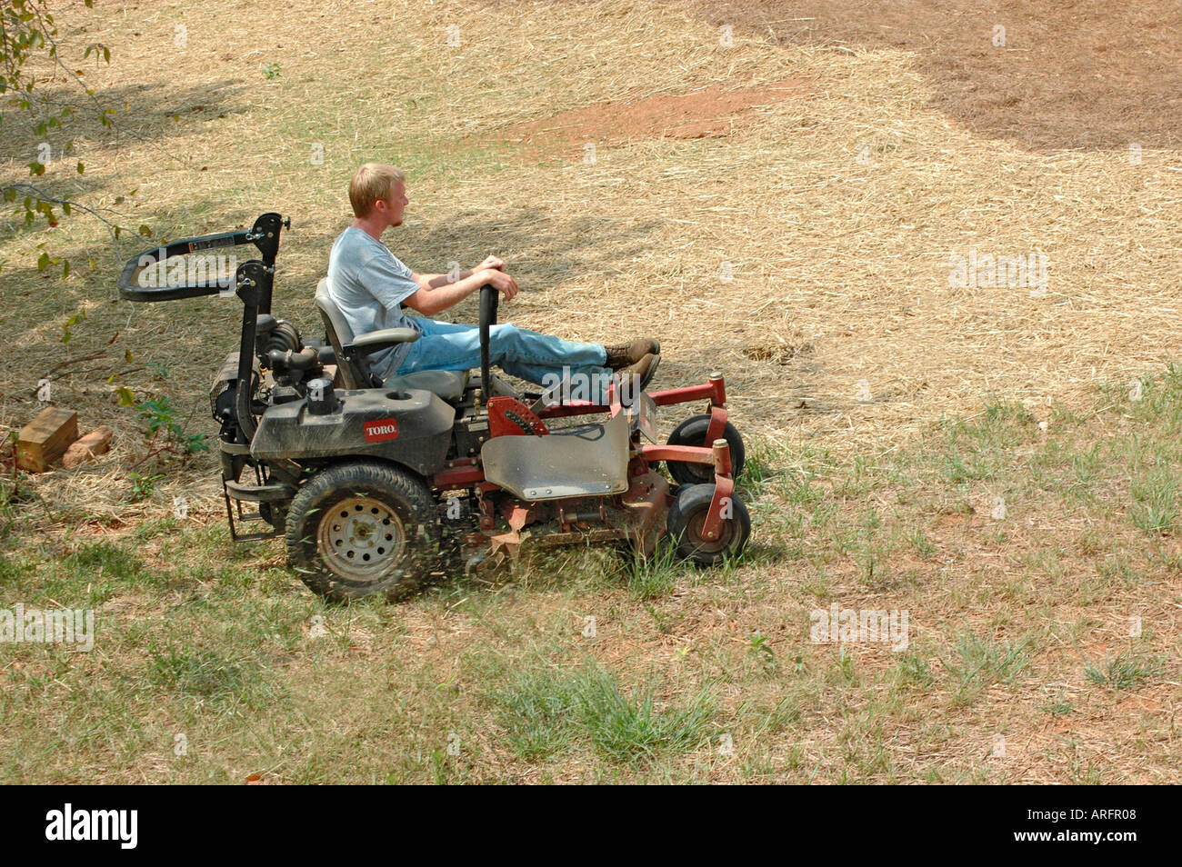Man Cutting Yard grass Lawn on Ridding Mower Southern USA America for a