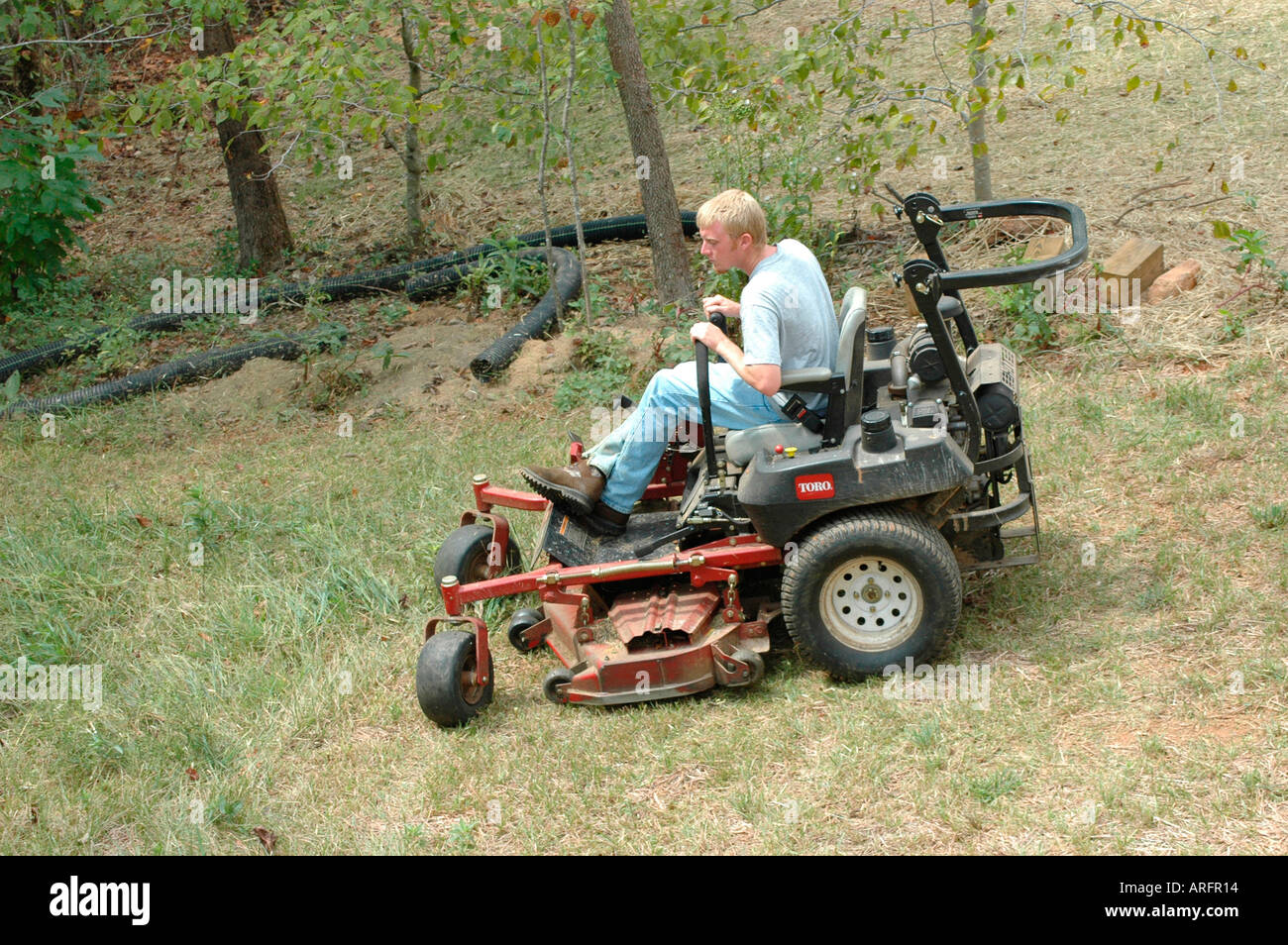 Man Cutting Yard grass Lawn on Ridding Mower Southern USA America for a