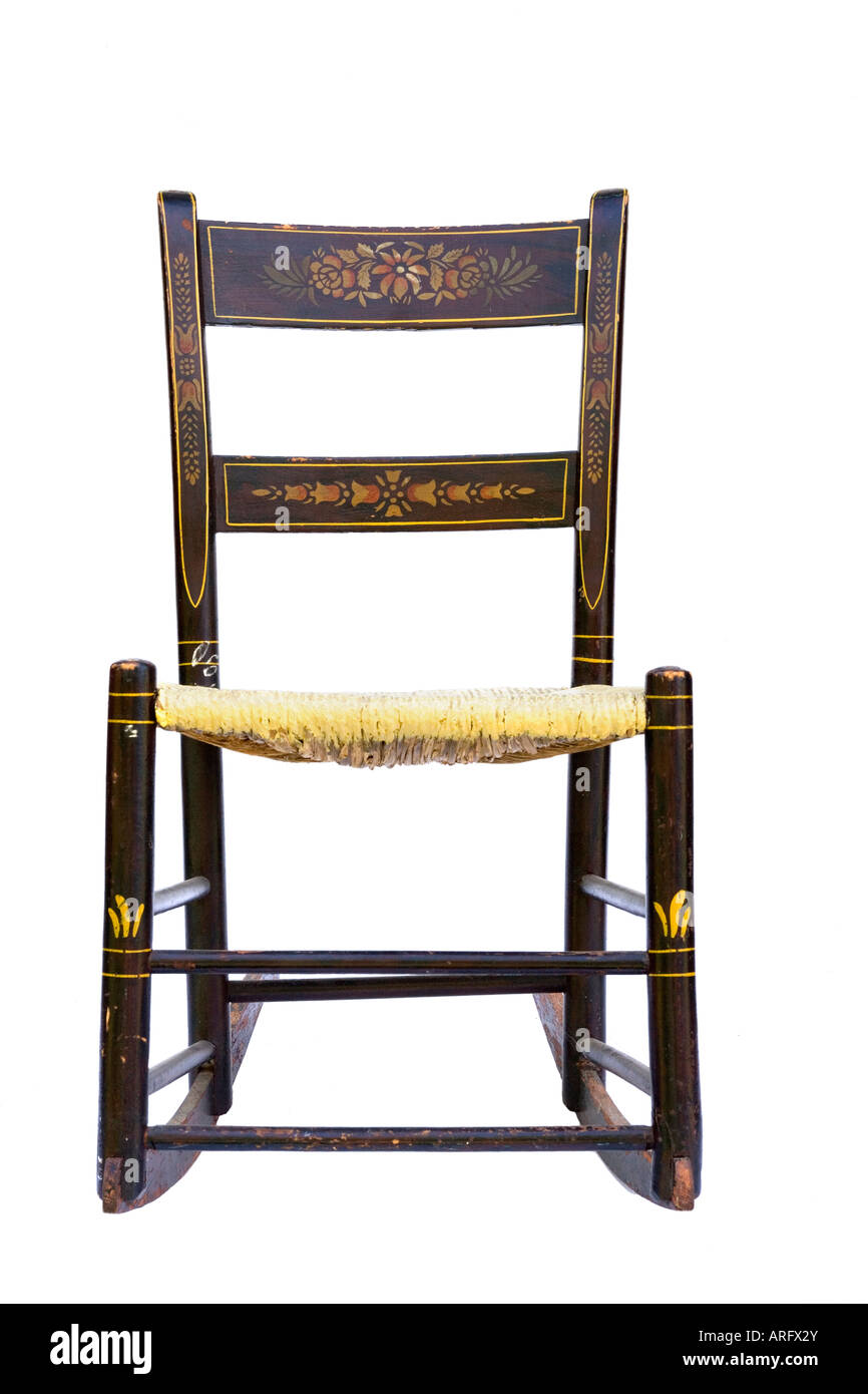 Antique rocking chair with woven rush seat silhouetted on white background Stock Photo