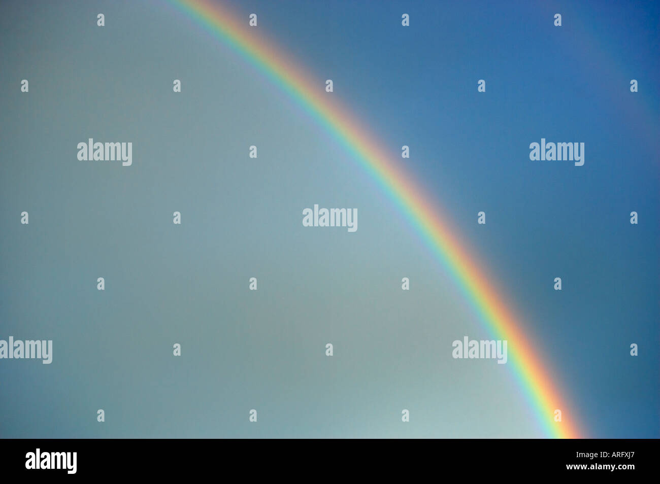 RAINBOW IN BLUE SKY AFTER RAIN Stock Photo - Alamy
