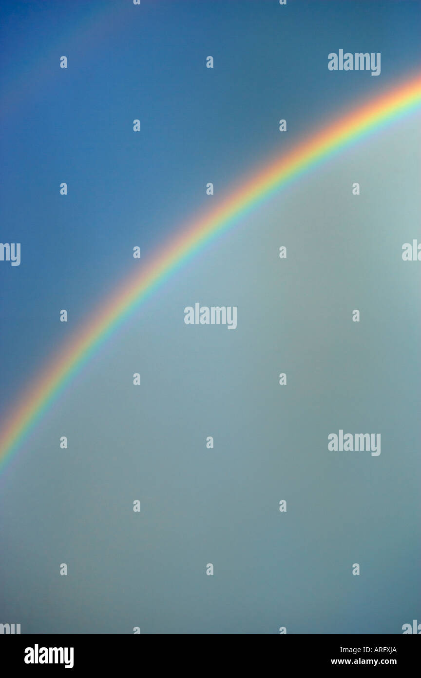 RAINBOW IN BLUE SKY AFTER RAIN Stock Photo - Alamy