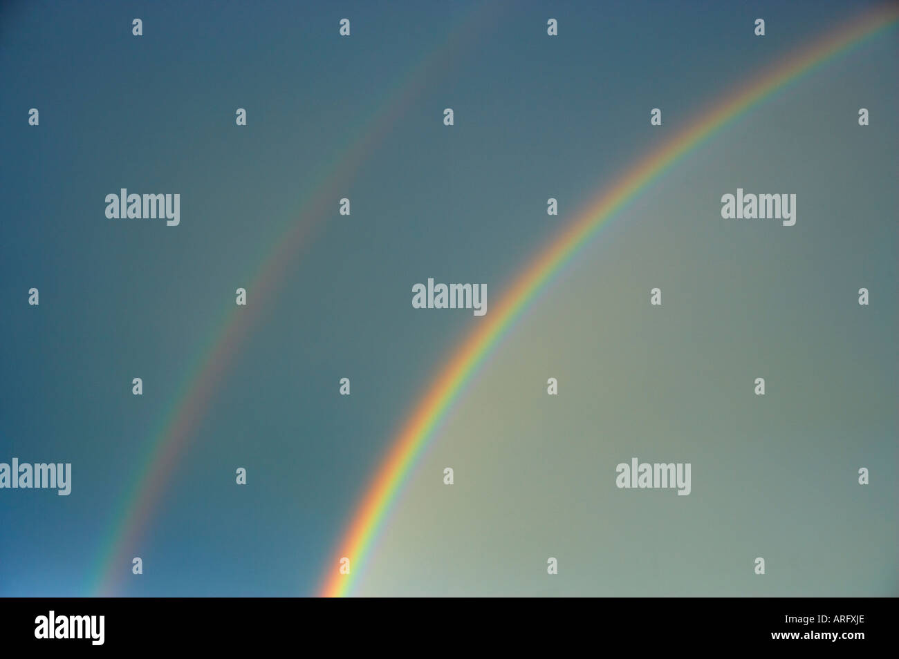 DOUBLE RAINBOW IN BLUE SKY AFTER RAIN Stock Photo - Alamy