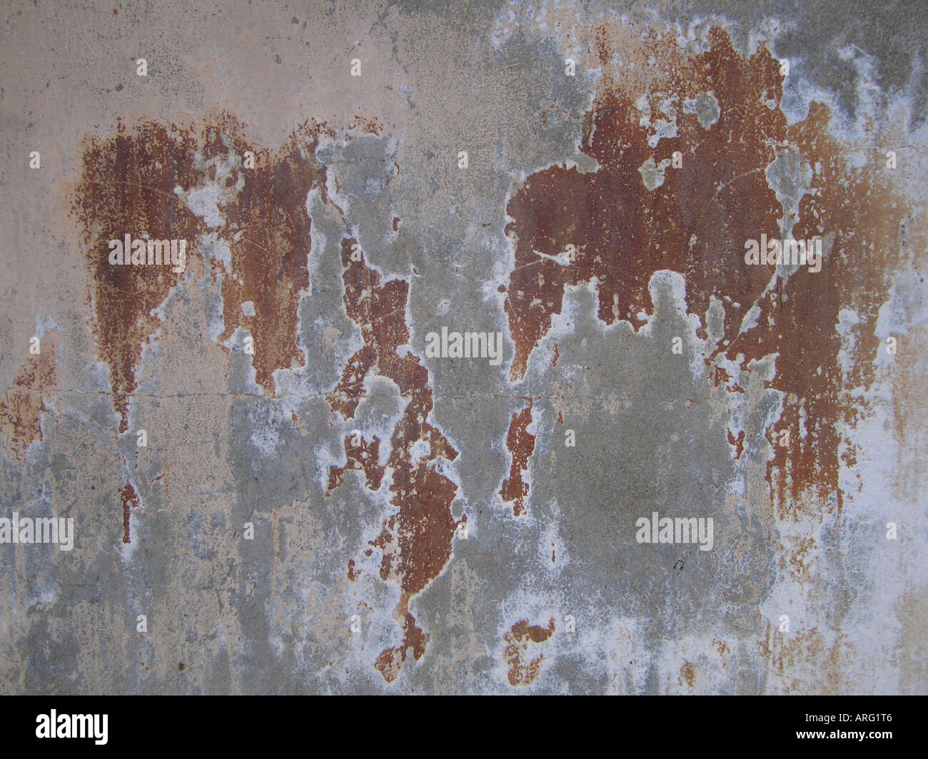 Worn concrete wall with rust colour showing Stock Photo