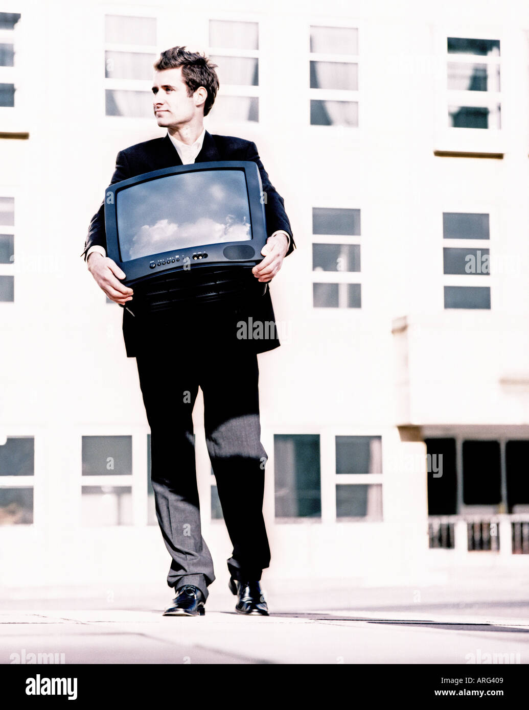 male carrying television outside sky reflected in screen Stock Photo