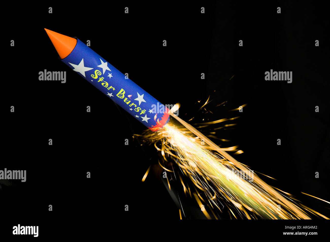 A firework rocket with trail of sparks captured against black Stock Photo