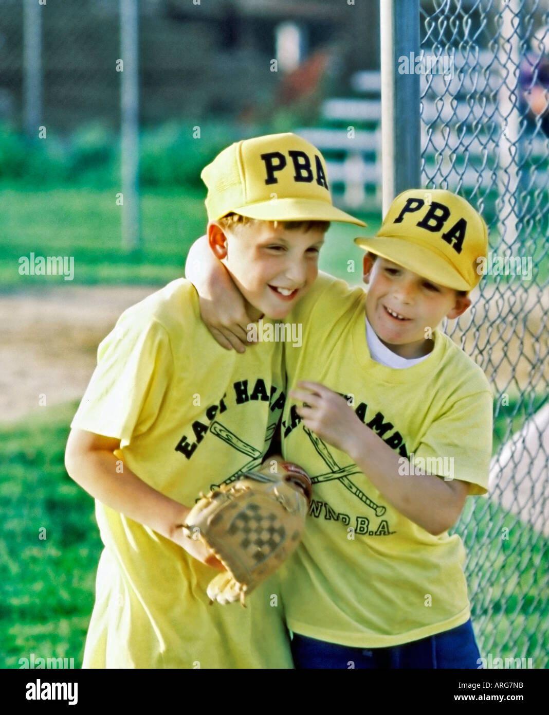 "EAST HAMPTON" NY USA Two Young Male Teens Hugging at Male "Baseball