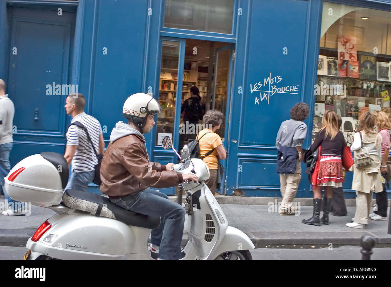 PARIS France, Crowd People, Facade of 'Les Mots à la Bouche'  Gay Bookstore, Man on Motorbike, busy street Paris shops (Now Closed) Stock Photo