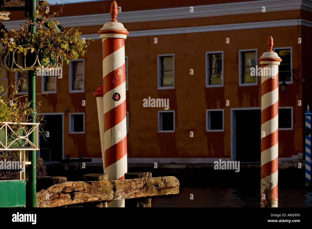 Typical white and red wooden poles in a canal of Venice Italy Stock Photo