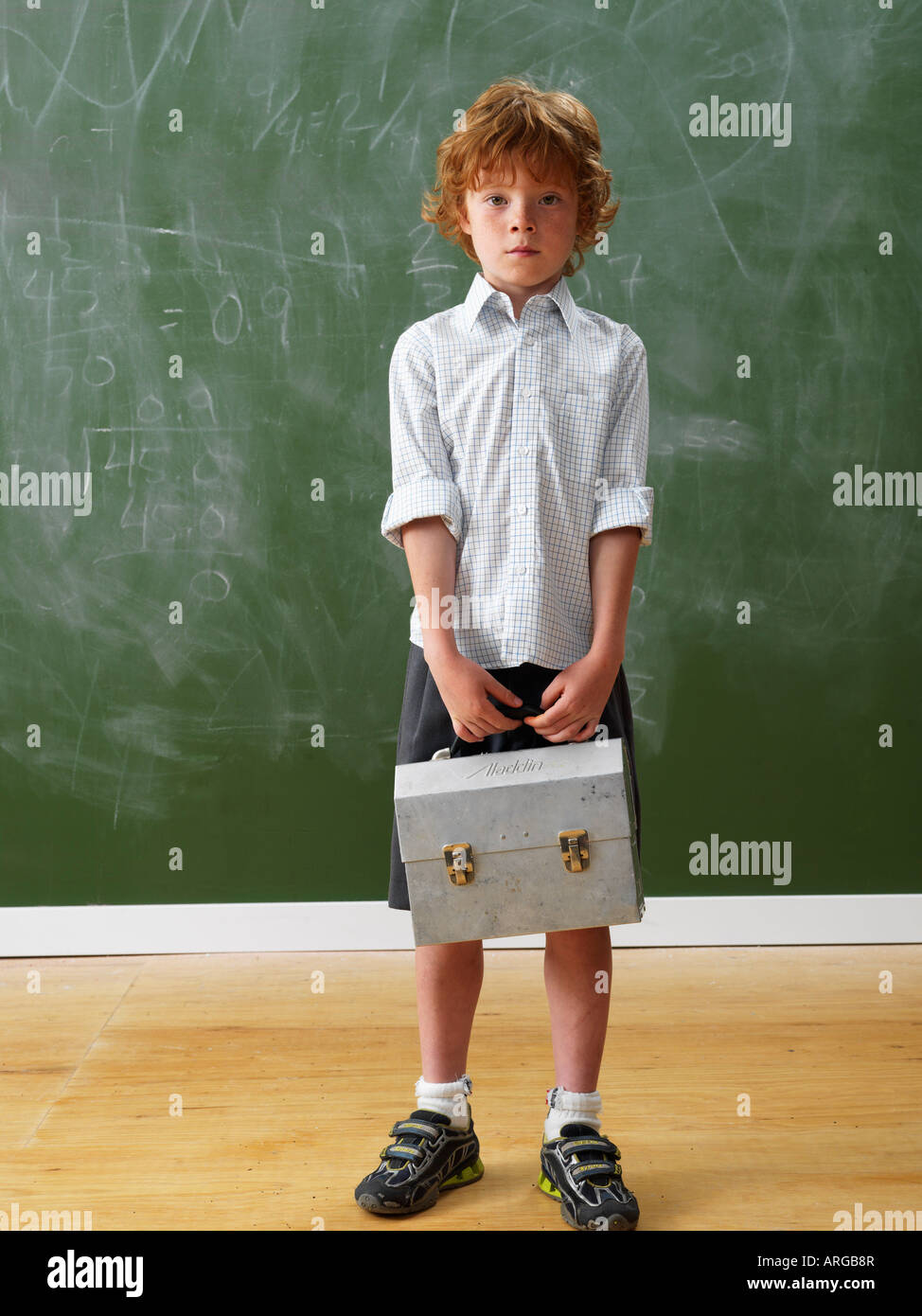 Boy Standing at Blackboard Stock Photo