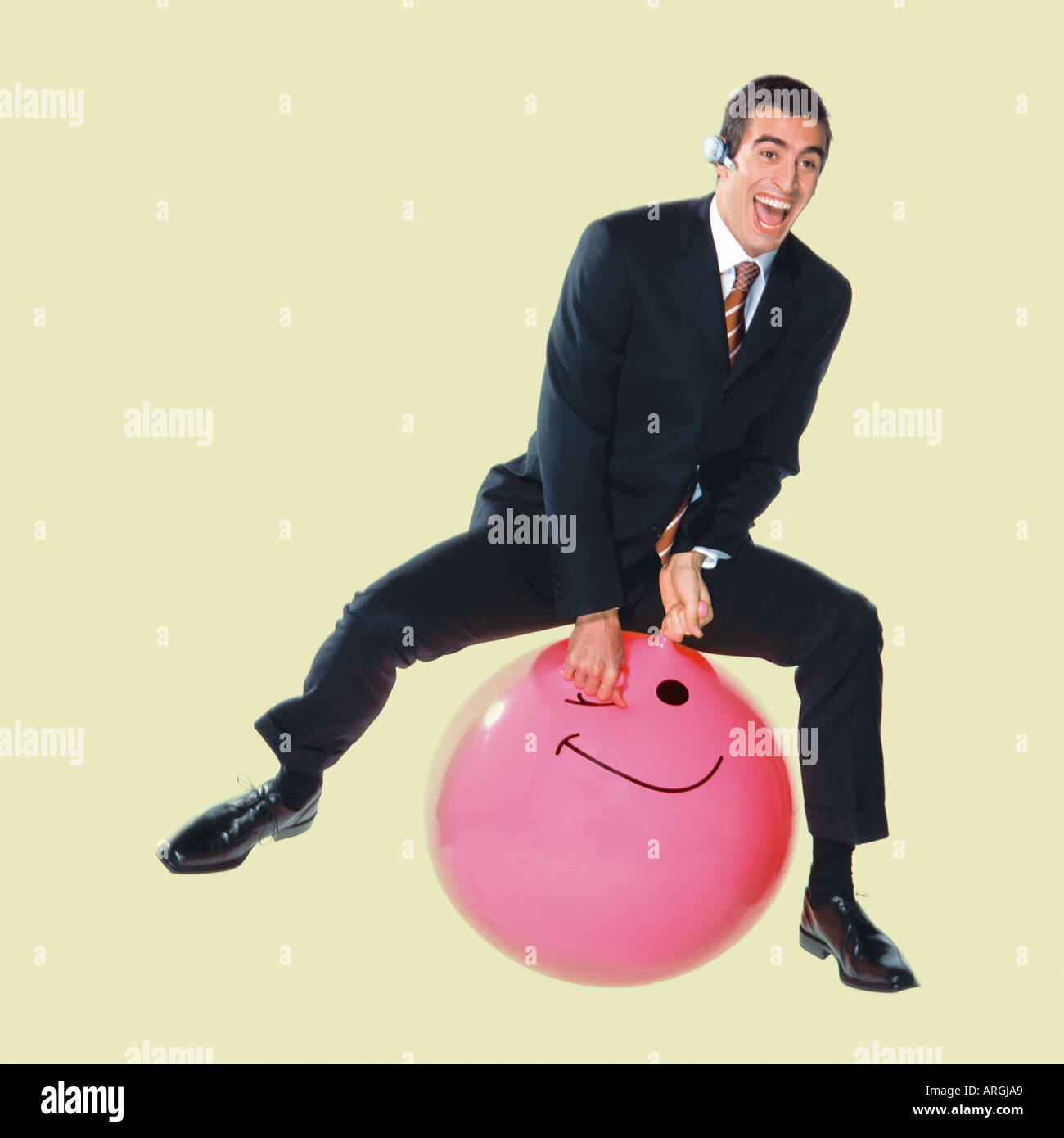 Businessman on Bouncy Ball Stock Photo