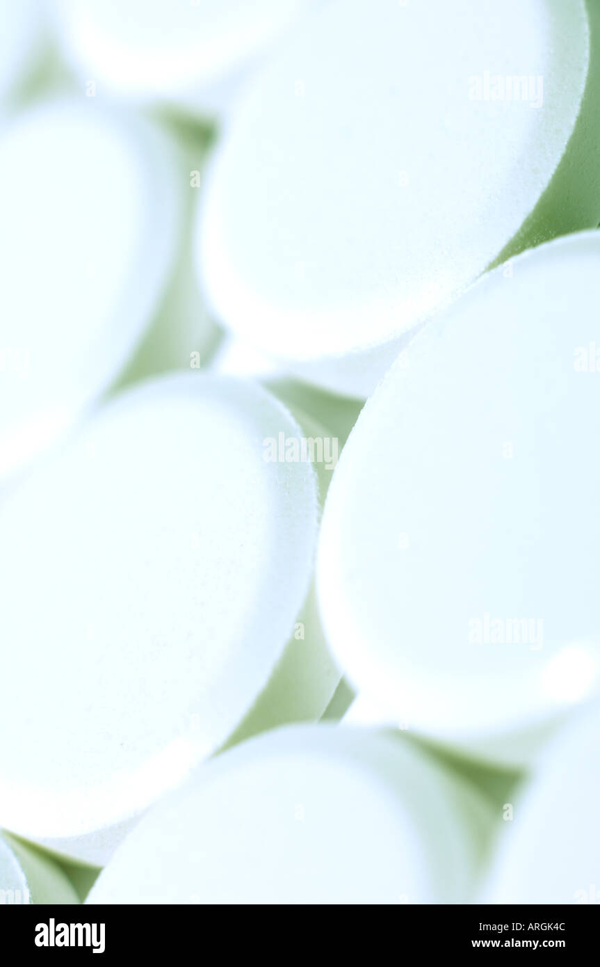 Small white medicinal tablets with fresh blue toning Stock Photo