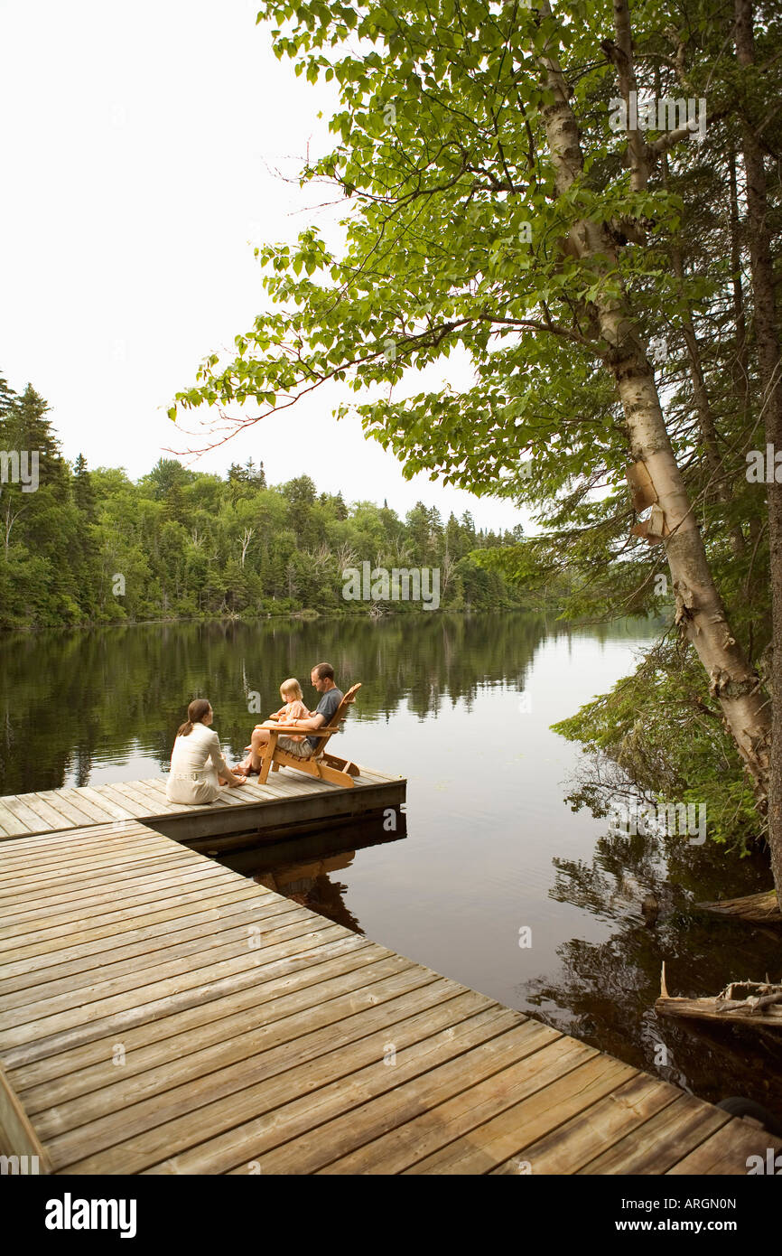 Family on Dock by Lake Stock Photo